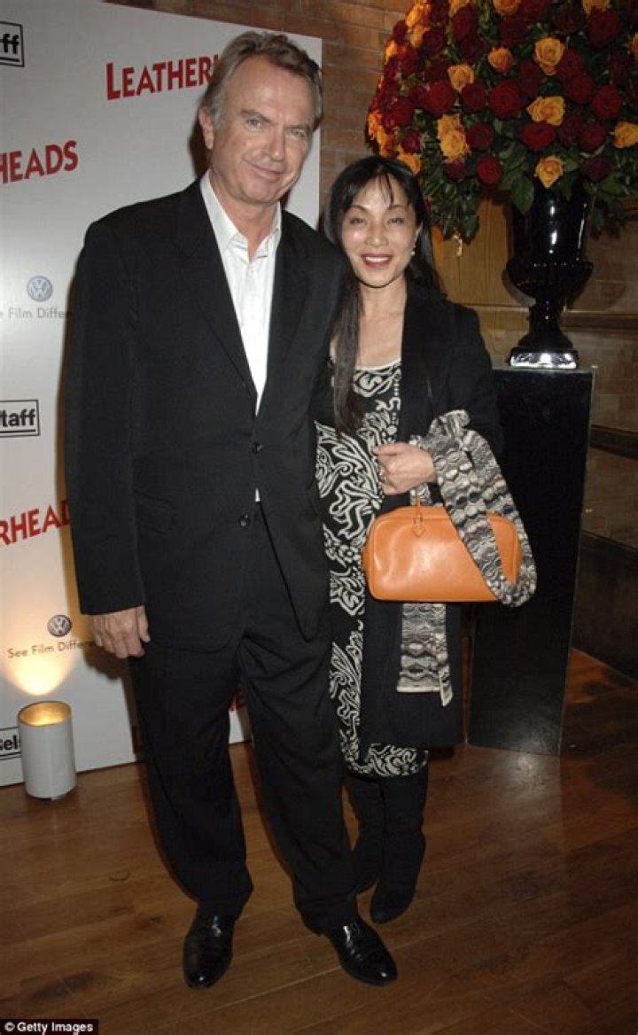 Married Sam Neill offers a woman a friendly kiss in Brisbane Daily